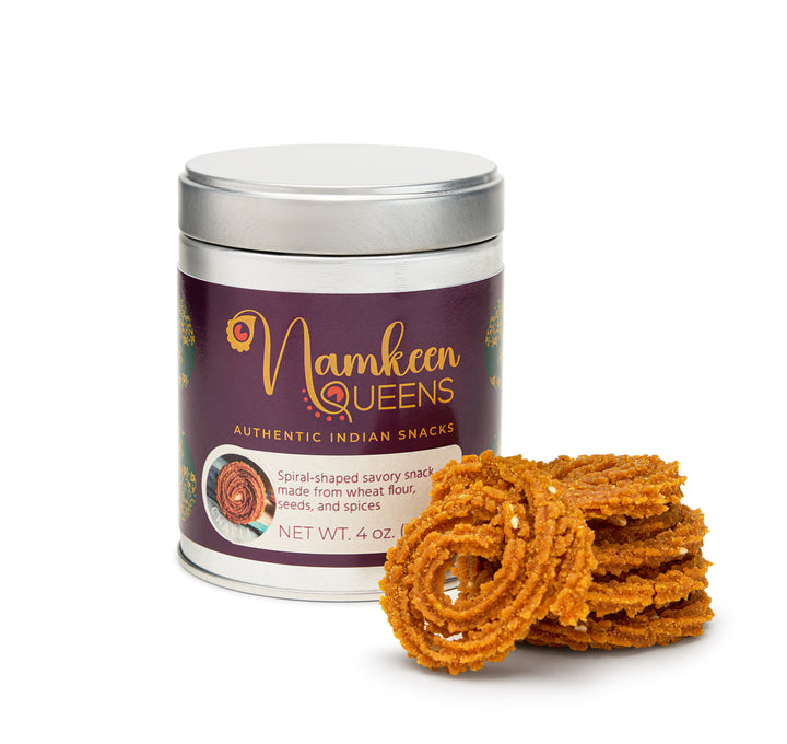 A 4 oz cylindrical metal tin with chakli placed next to it. 